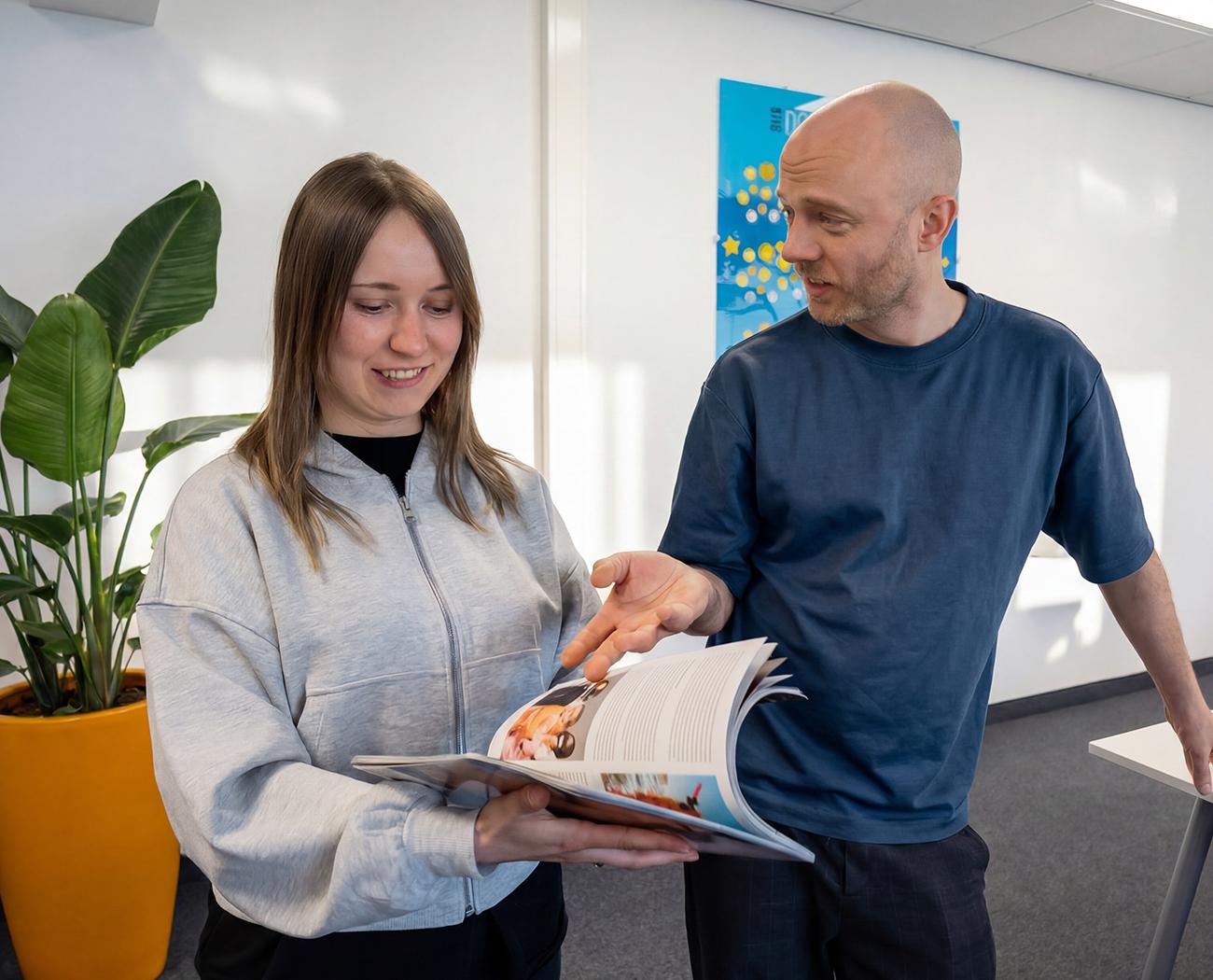 SEA Ad Formats | Two people looking at a magazine