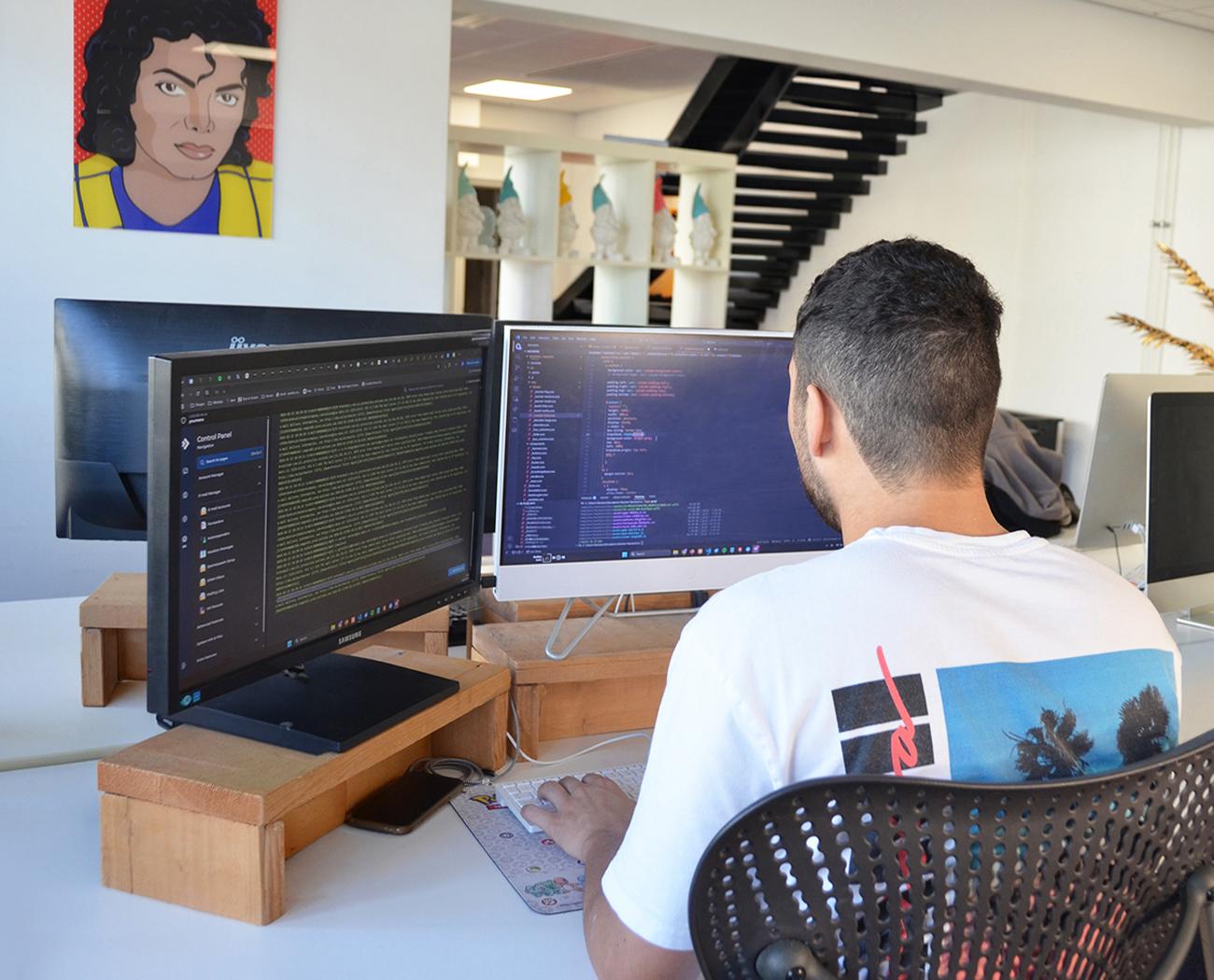 A CMS for your website | A man is coding on a computer