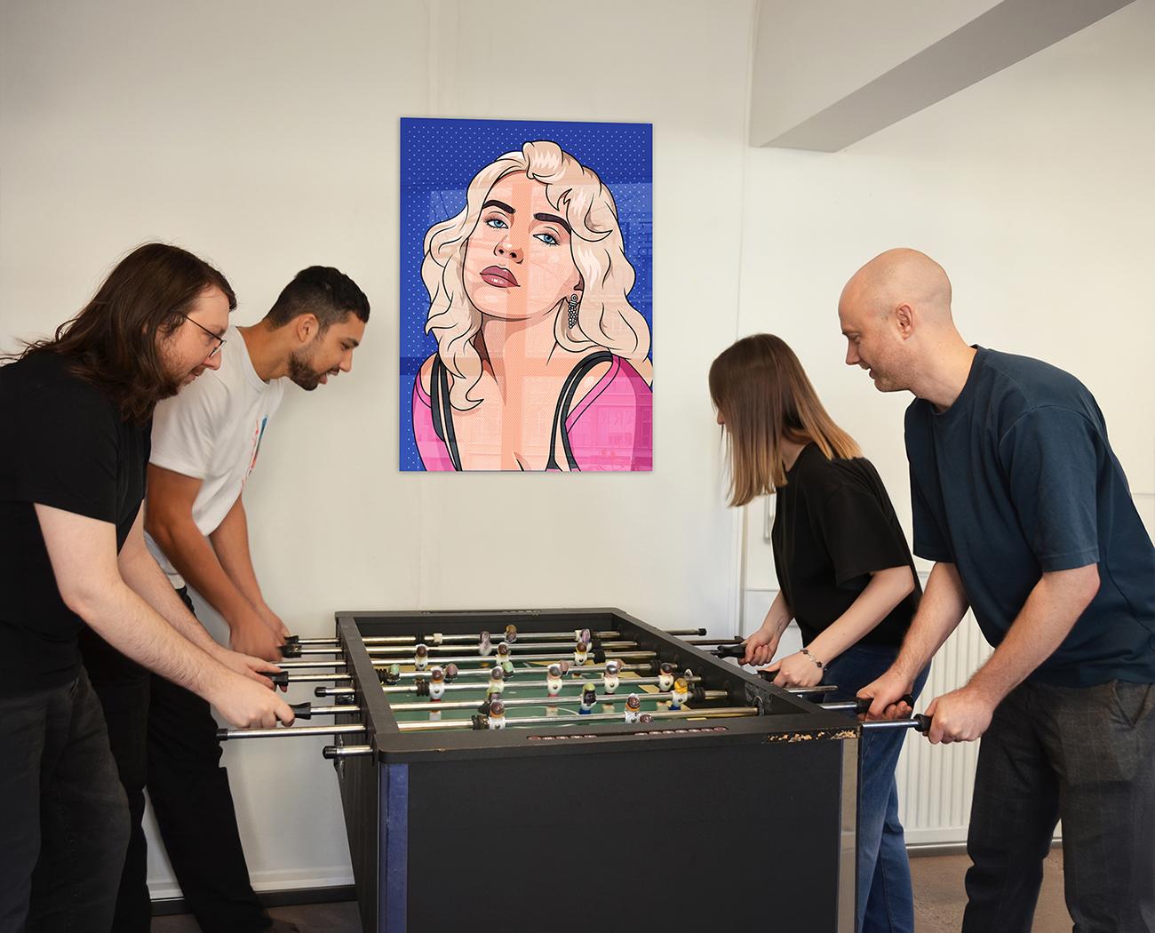 Employer Branding | Four people are playing foosball